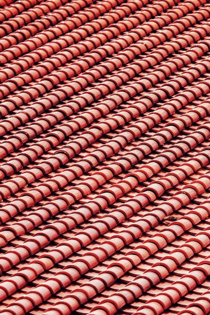 pexels-photo-17680681-17680681 Detailed close-up of red roof tiles showcasing texture and design in a vertical shot.
